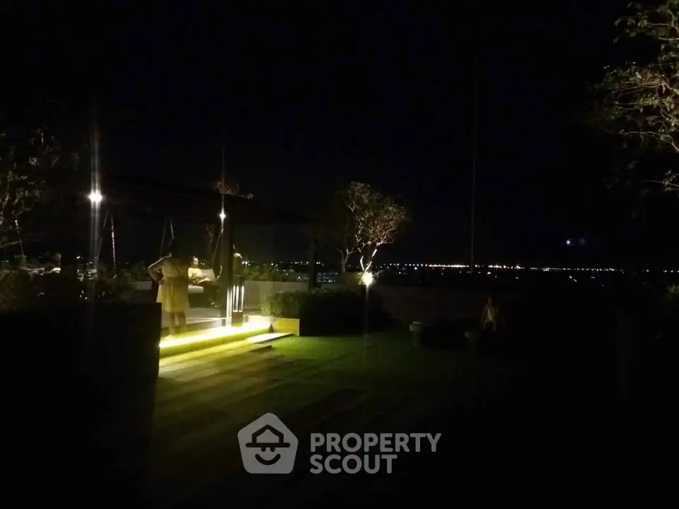 Stunning rooftop view with ambient lighting and city skyline at night.