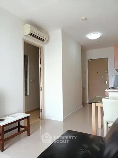 Modern living room with sleek furniture and air conditioning in a bright apartment.