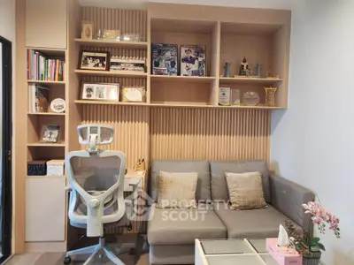 Modern study room with ergonomic chair, cozy sofa, and stylish shelving for a perfect work-from-home setup.