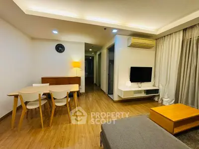 Modern living room with wooden flooring and stylish furniture in a cozy apartment.