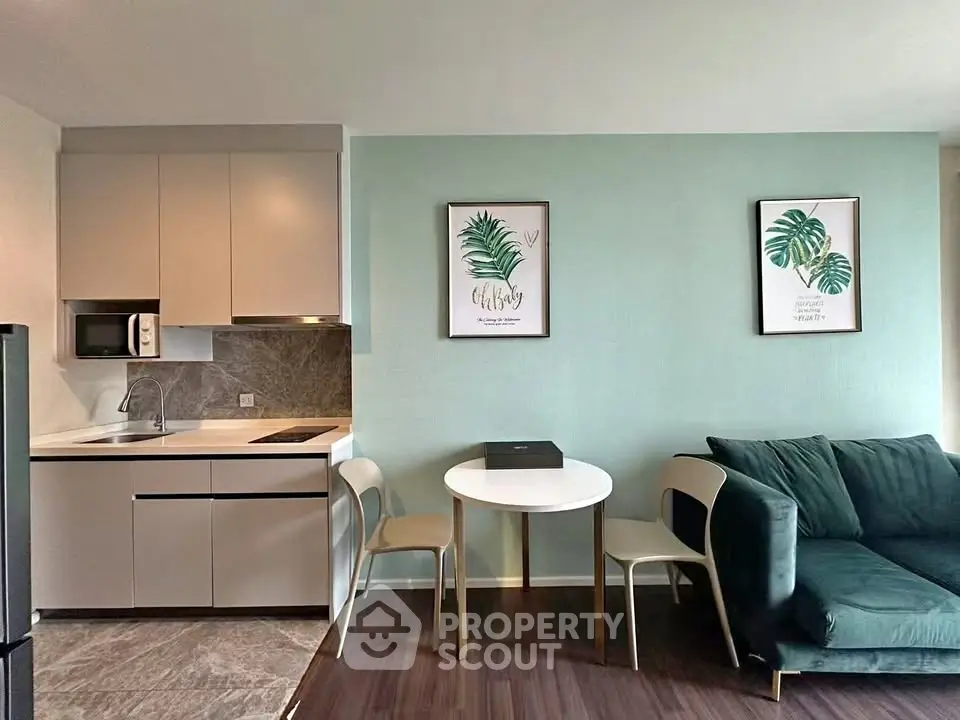 Modern open-layout kitchen and living area with stylish decor and cozy seating.