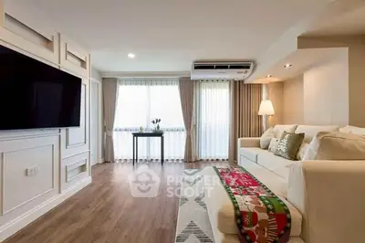 Spacious living room with modern decor and large windows for natural light.