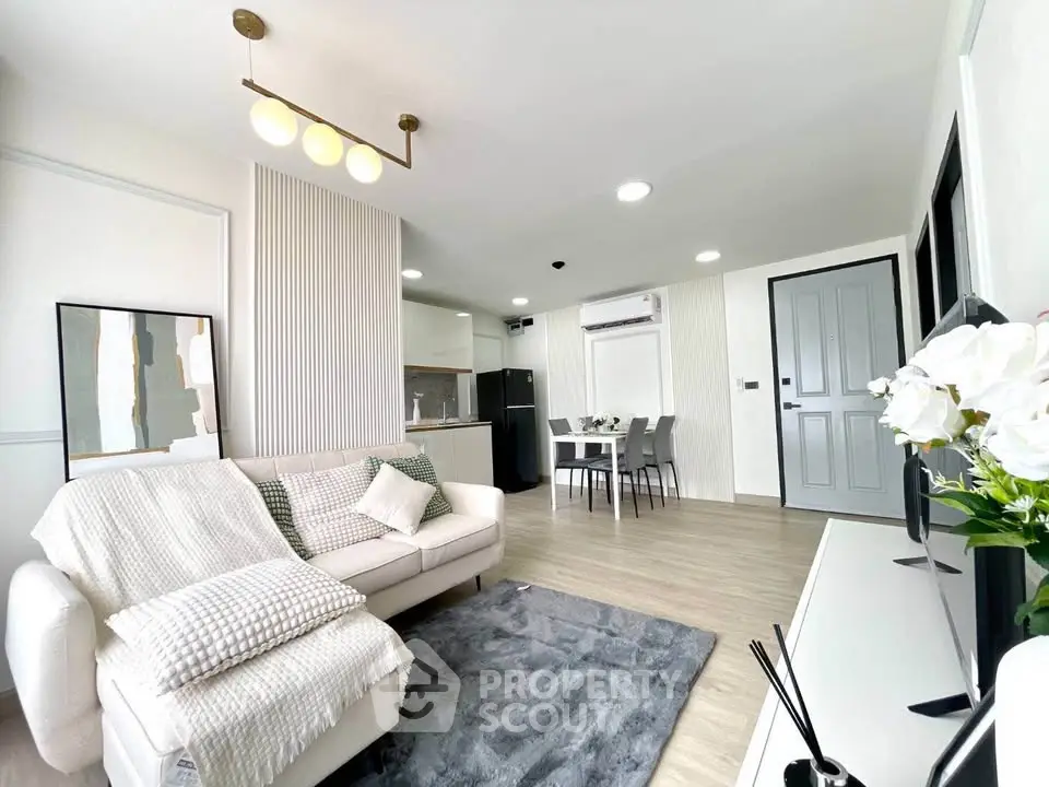 Modern living room with cozy decor and open kitchen layout