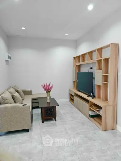 Modern living room with sleek furniture and large TV unit
