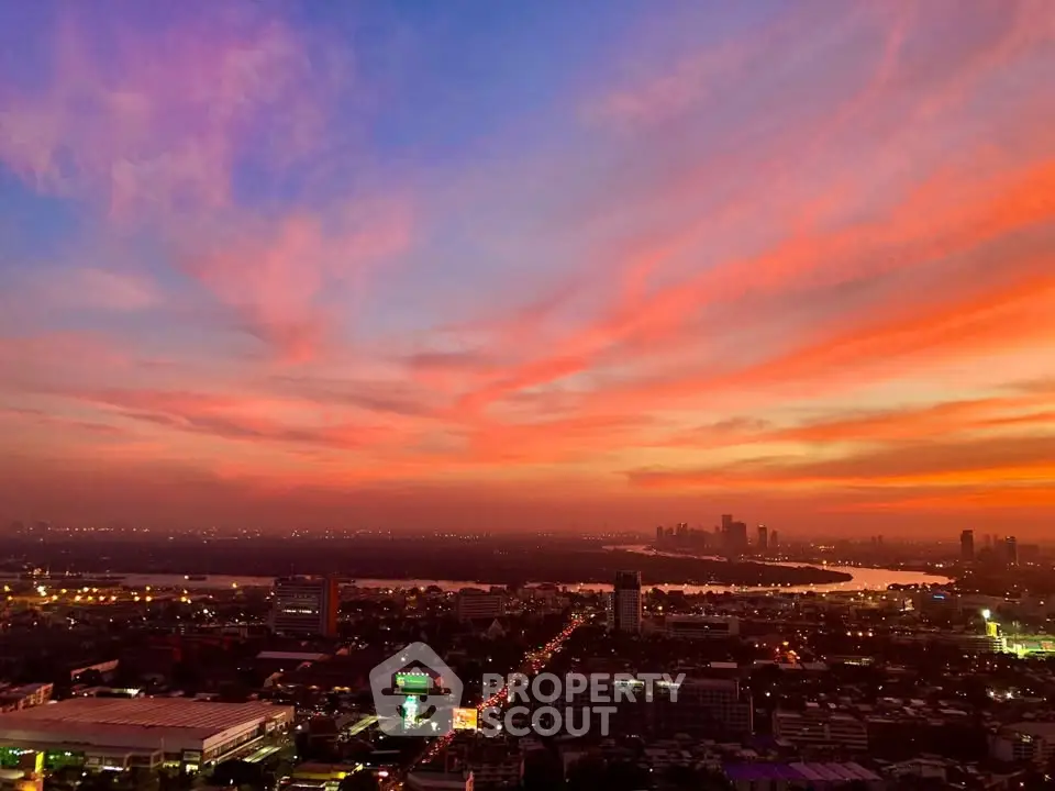 Stunning cityscape view with vibrant sunset sky over urban skyline and river.