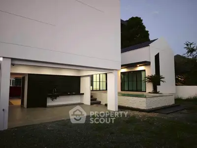 Modern minimalist house exterior with sleek design and large windows, showcasing contemporary architecture.