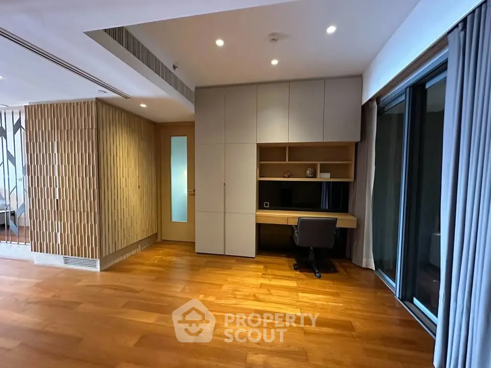 Spacious modern study room with wooden flooring and built-in desk
