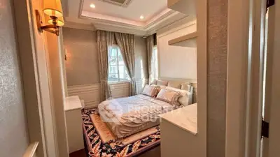 Luxurious bedroom with elegant decor and large windows in a modern apartment.