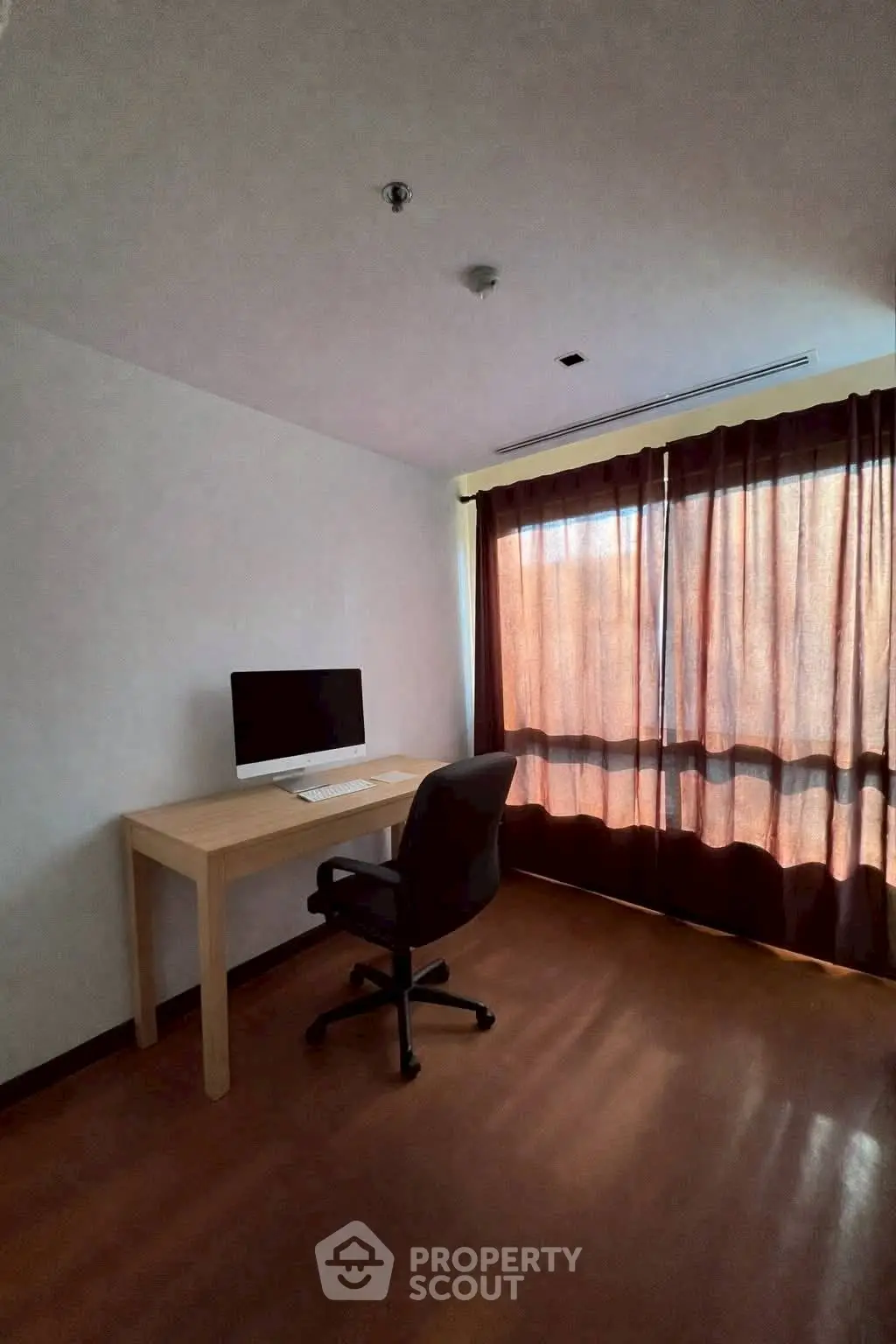 Spacious study room with natural light and modern desk setup