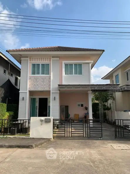 Charming two-story house with modern design and spacious driveway in a serene neighborhood.