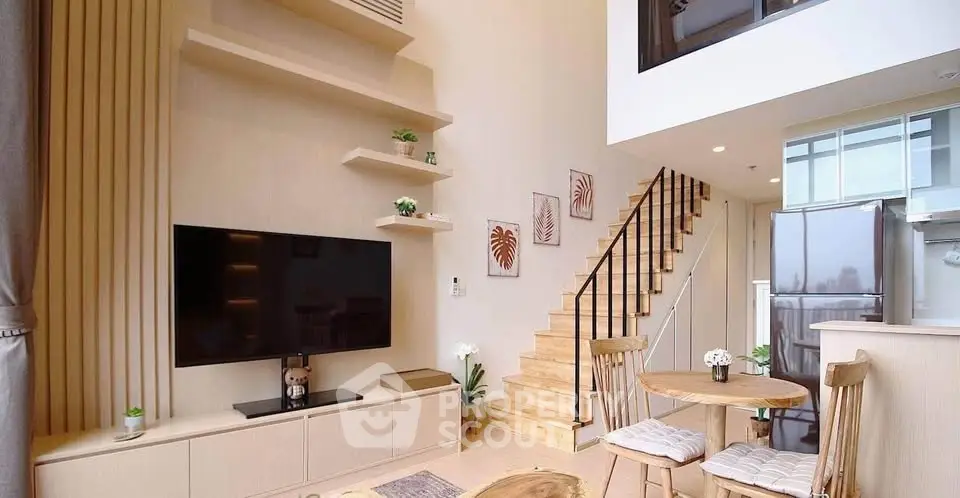 Modern duplex living room with stylish decor and open kitchen layout