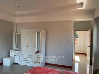 Spacious bedroom with elegant wardrobe and natural light
