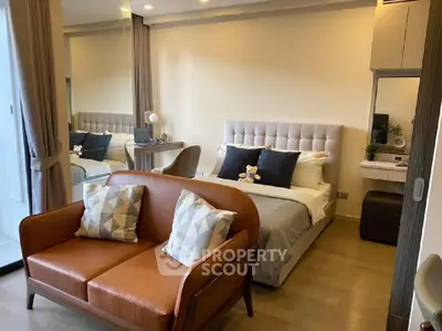 Stylish modern bedroom with cozy seating and elegant decor