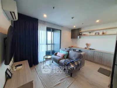 Modern living room with cozy sofa, stylish decor, and balcony view in a contemporary apartment.