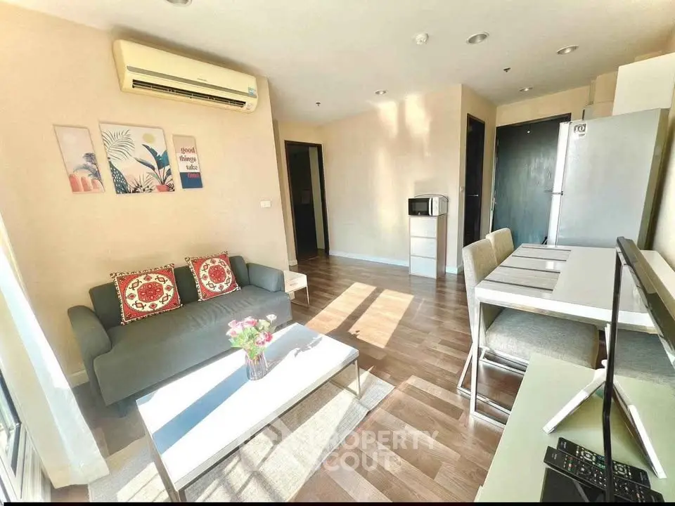 Modern living room with stylish decor, air conditioning, and natural light, perfect for relaxation and entertaining.