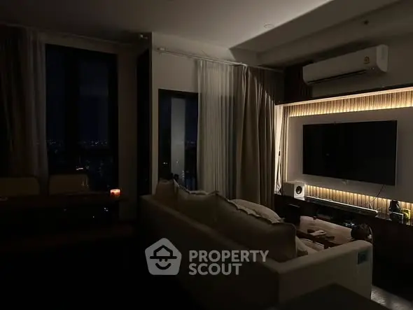Cozy living room with ambient lighting and city view at night.