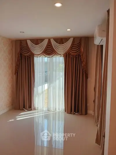 Elegant living room with luxurious drapes and natural light