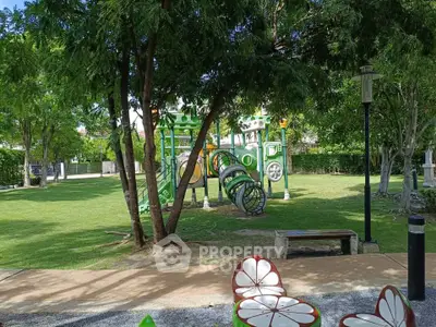 Charming residential playground with lush greenery and modern play equipment, perfect for family-friendly living.