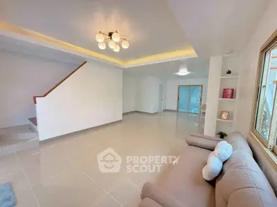 Spacious modern living room with elegant lighting and cozy sofa