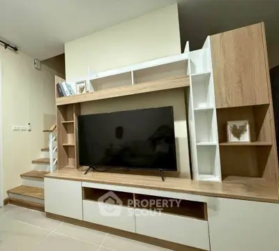 Modern living room with stylish TV unit and shelving
