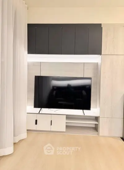 Modern living room with sleek TV unit and elegant curtains