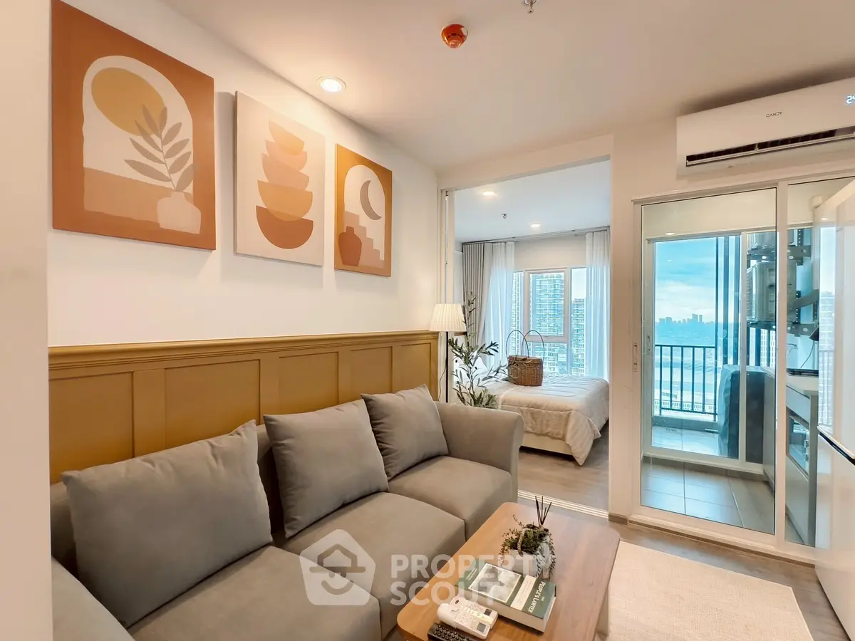 Modern living room with cozy sofa and balcony view in stylish apartment.