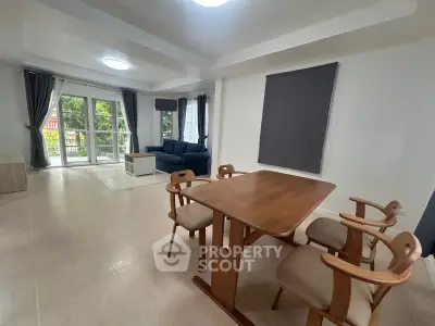 Spacious living room with modern furniture and large windows offering natural light.