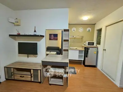 Cozy studio apartment with modern kitchen and stylish living area, perfect for urban living.