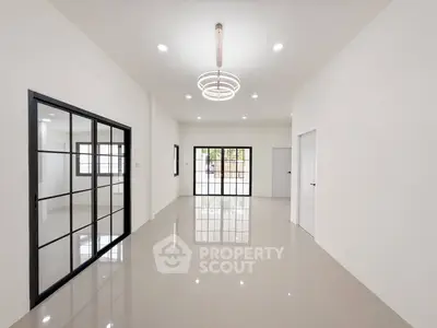 Spacious modern living room with elegant lighting and large windows