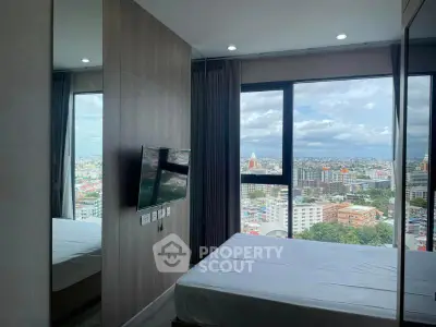 Modern bedroom with stunning city view from large window, featuring sleek design and wall-mounted TV.
