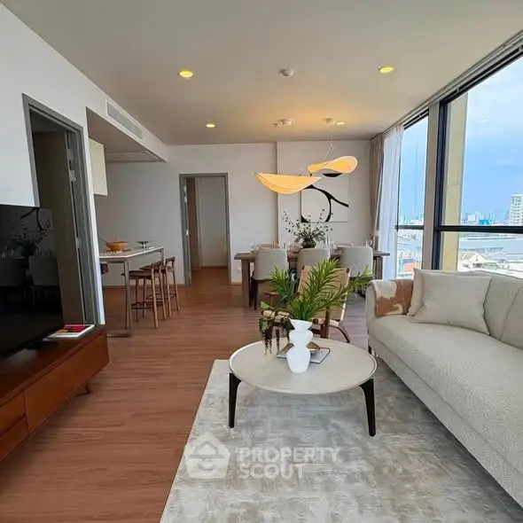 Spacious modern living room with open layout and stunning city view