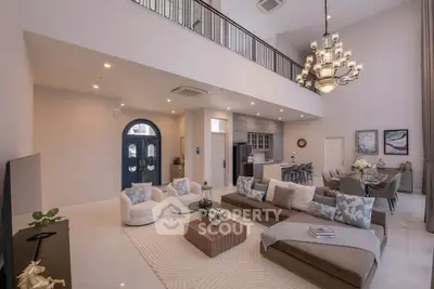 Luxurious open-plan living room with high ceilings and elegant chandelier