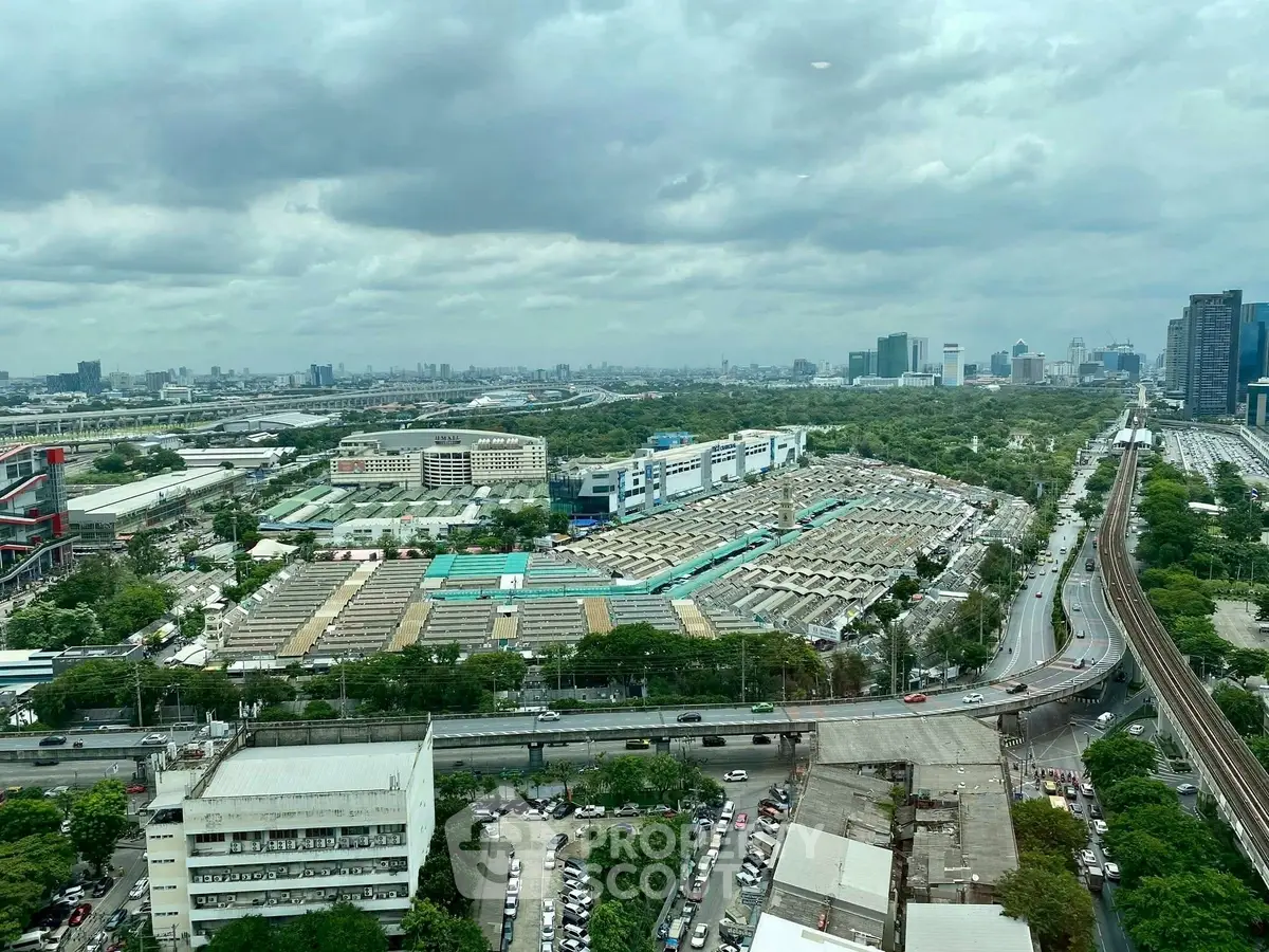 Stunning cityscape view from high-rise building showcasing urban landscape and greenery.