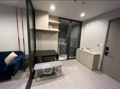 Modern apartment interior with sleek design and cozy seating area.