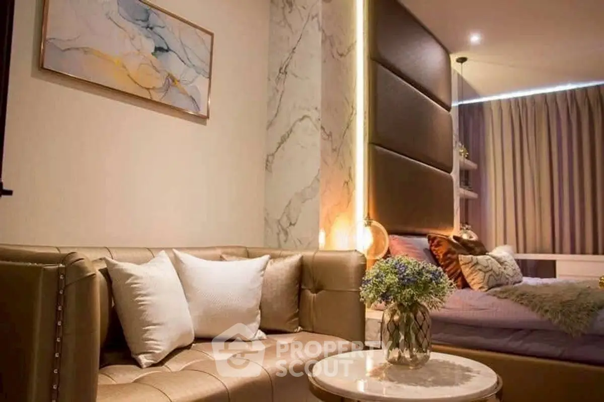 Luxurious modern bedroom with elegant decor and cozy seating area.
