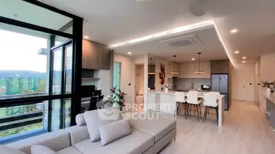 Modern open-plan living room with kitchen and scenic view