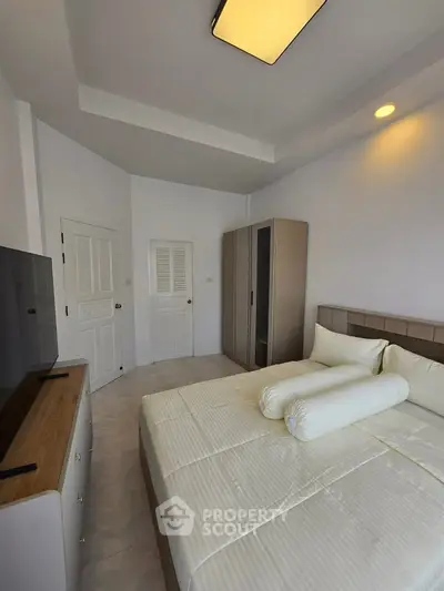 Spacious bedroom with modern furnishings and ample storage space
