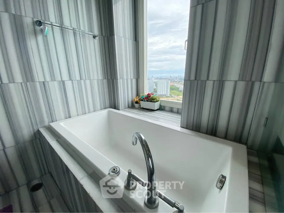 Luxurious bathroom with a stunning city view from the bathtub, perfect for relaxation.