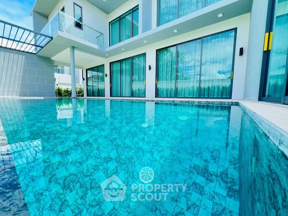 Luxurious modern villa with stunning pool and spacious balcony, perfect for relaxation and entertainment.