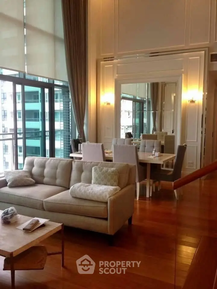 Luxurious living room with high ceilings and elegant decor in a modern apartment.