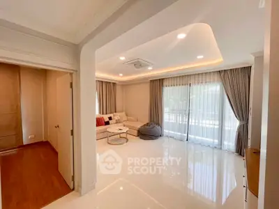 Spacious living room with elegant decor and large windows for natural light
