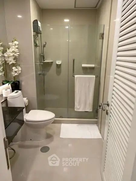 Modern bathroom with glass shower and sleek fixtures