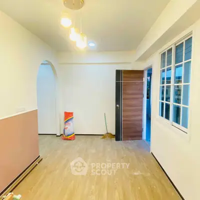 Modern interior with wooden flooring and stylish lighting in a spacious room