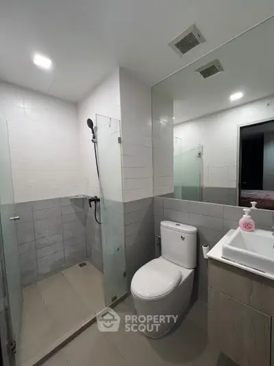 Modern bathroom with glass shower and sleek fixtures