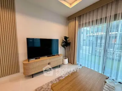 Modern living room with large TV and elegant decor, featuring floor-to-ceiling windows and stylish furniture.