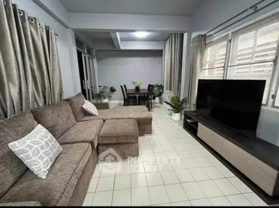 Spacious living room with modern decor and large windows for natural light.