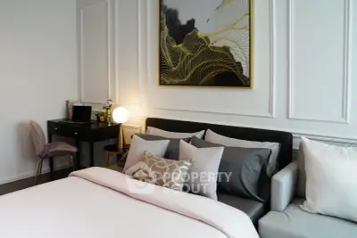 Luxurious bedroom with elegant decor and stylish furniture, featuring a cozy bed and modern artwork.