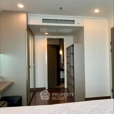 Modern bedroom with built-in wardrobe and sleek wooden flooring