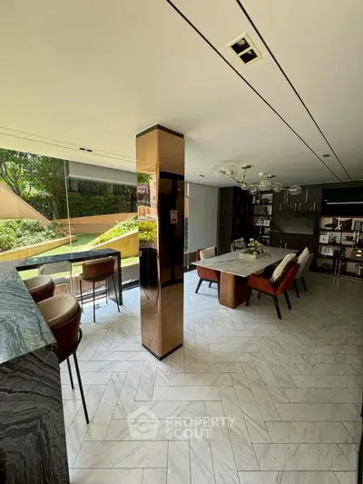 Luxurious modern kitchen and dining area with large windows and stylish decor