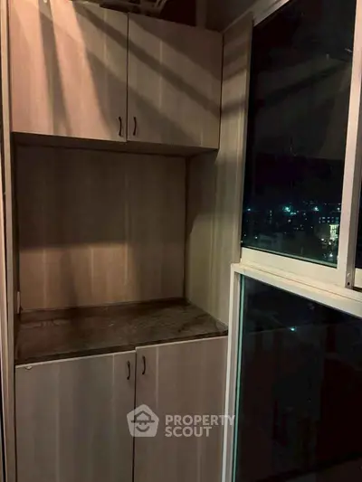 Stylish balcony with built-in storage and stunning night city view.